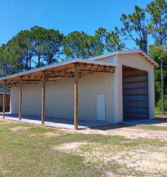 Fully enclosed Patriot Pole Barn with open lean-to built in Brooksville, FL by Patriot Pole Barns, used as an RV cover and equipment storage building