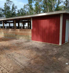 Lean-to horse barn with 3 stalls and enclosed feed/tack room built in Dade City, FL by Patriot Pole Barns, used as a multipurpose tack room