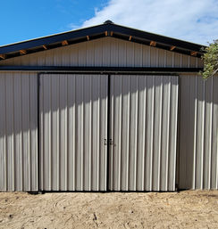 Custom steel truss barn with sliding barn doors built in Dade City, FL by Patriot Pole Barns, used as an equipment shelter