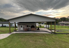 44x33x12 gable top steel truss pole barn with enclosures built in Spring Hill, FL by Patriot Pole Barns, used as a porch cover