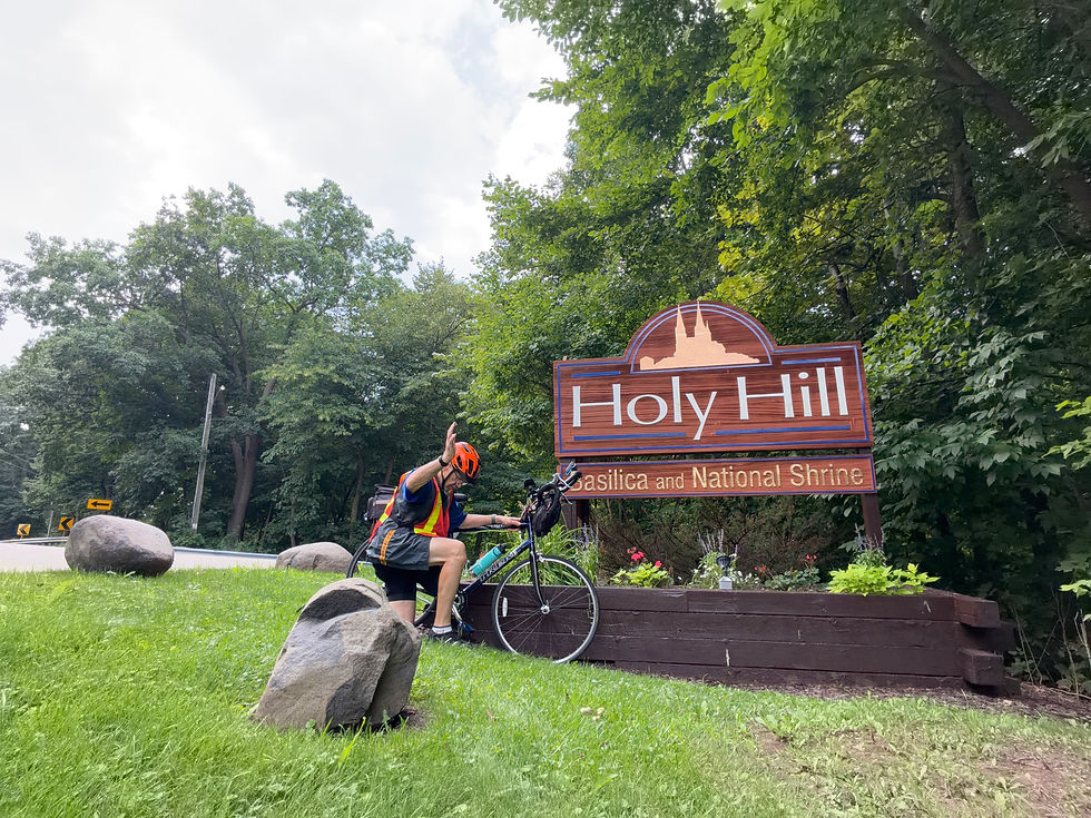 Ken Webster and his bicycle at Holy Hill beneath an overcast sky.
