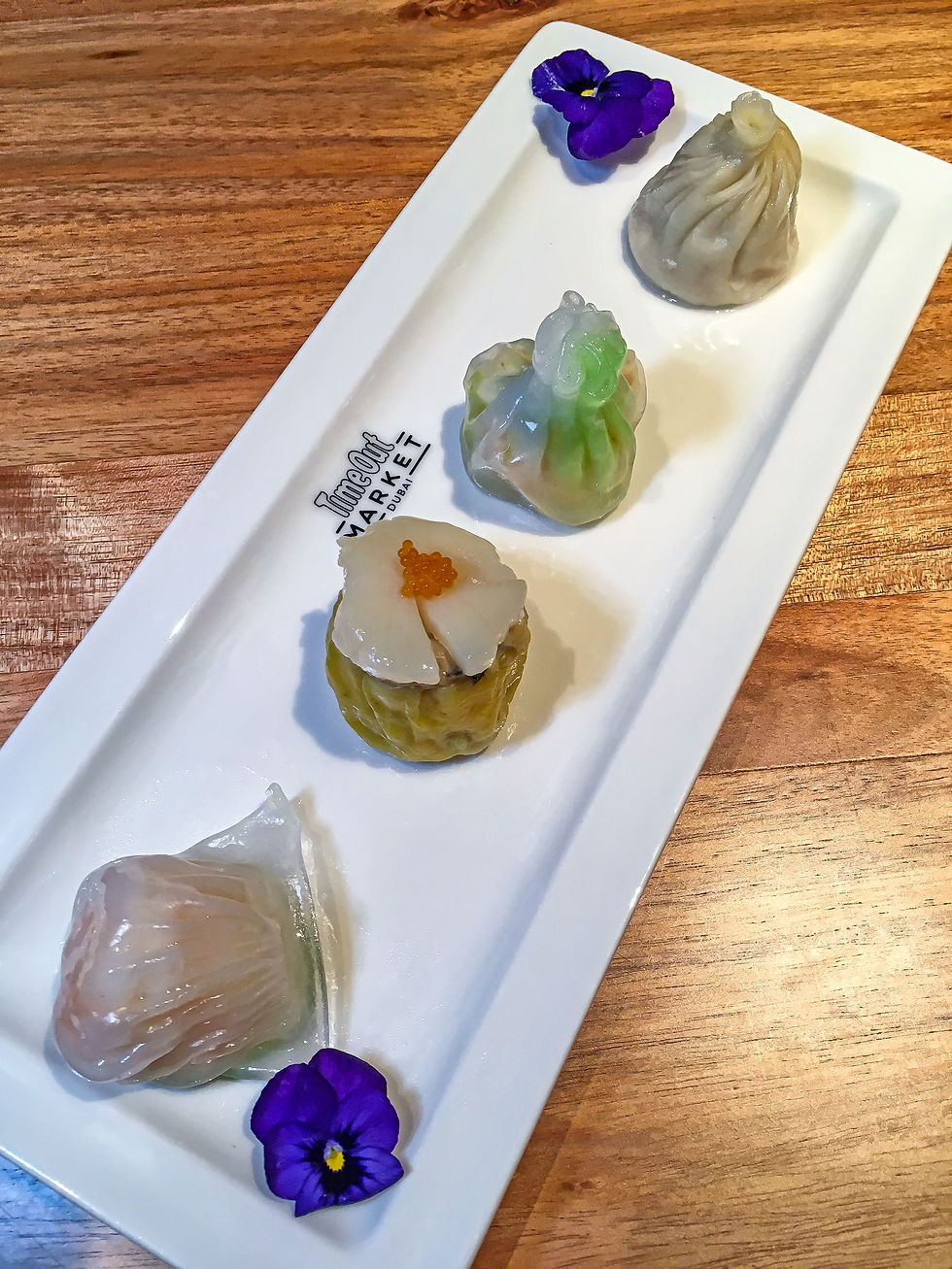 Steamed Dim Sum Platter with Chicken Xiaolong Bun (soup dumpling), Crystal Prawn Dumpling, Prawn & Chinese Cabbage Dumpling, and a Scallop & Chicken Sew Mai.