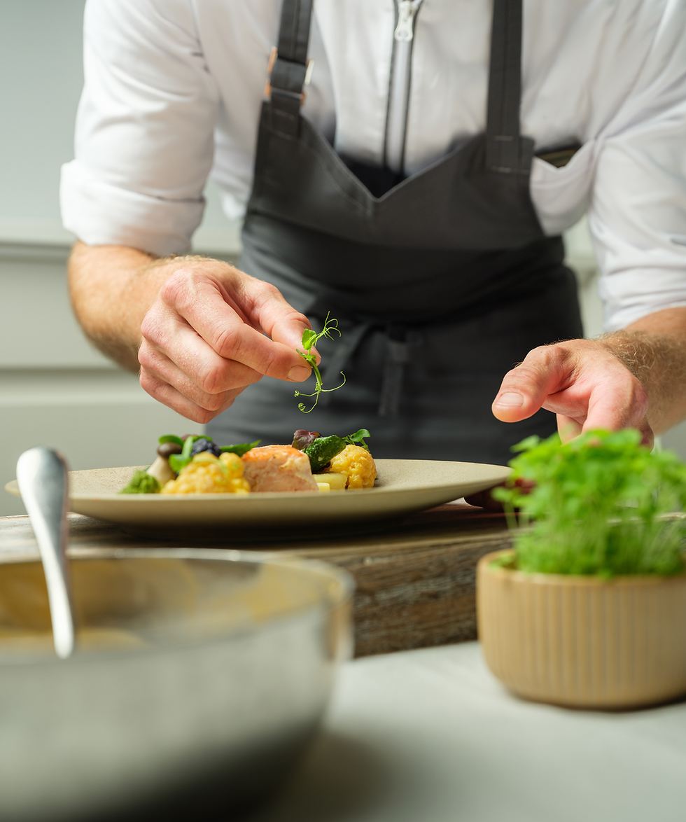Chef prepares a sophisticated vegetable dish in the catering department.