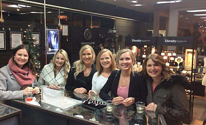 A group of six woman standing in front of a shop counter at an event held at Eternity Jewellery in Grande Prairie.