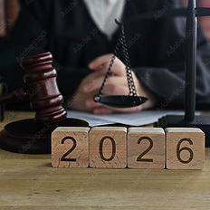 Judge with gavel and scales with wooden blocks showing the year 2026.