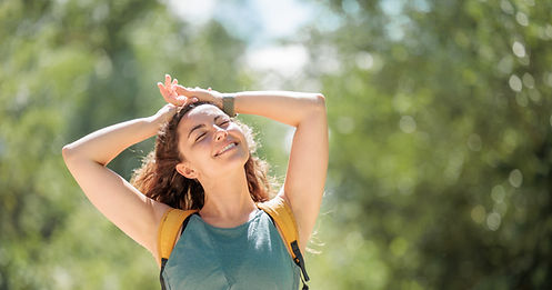 Young woman enjoying nature.Hiking in the mountains, observing the landscape.Doing sports