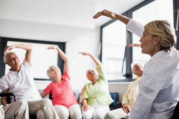 fitness instructor leadin stretching excercises to seniors.