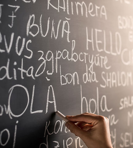 A chalk board with words translated into multiple languages