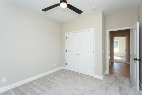 Bedroom with closet, ceiling fan, and grey carpet