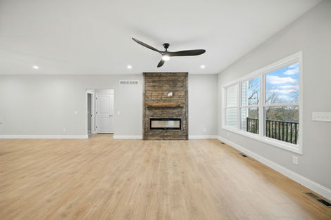 Living room at 31998 Fairway Dr North with stone fireplace, wood floor