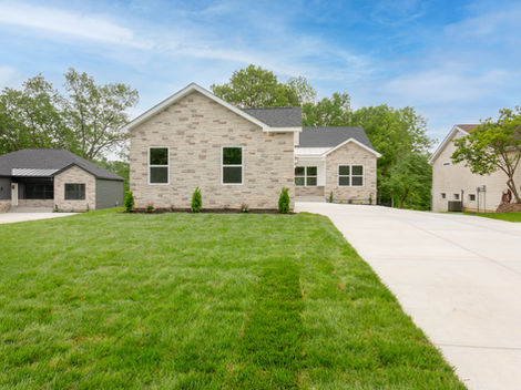 Light brick house, green lawn, driveway to 2027 Maury