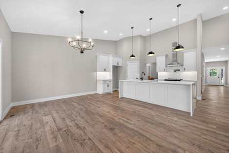 Open kitchen and living area with hardwood floors.