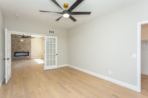Room with wood floor, light walls, and French doors