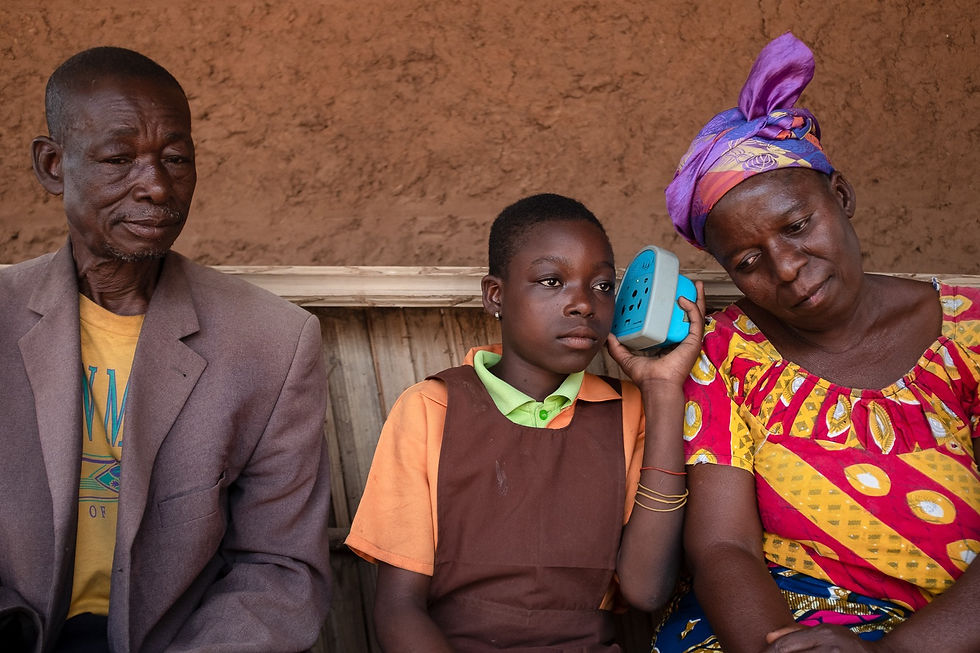 A family in northern Ghana listen to Talking Book messages together.