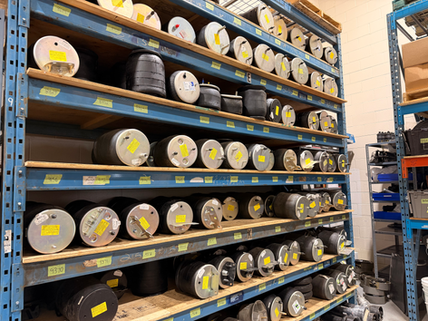 Shelves stocked with automotive belts and replacement drive components