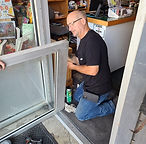 Person repairing a glass door