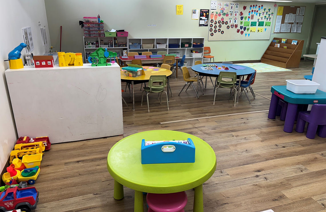 A school classroom featuring a table surrounded by several chairs