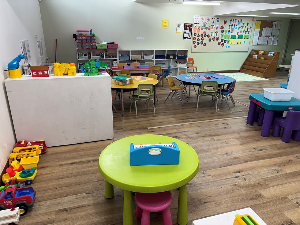 A school classroom featuring a table surrounded by several chairs