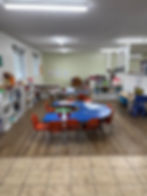 A classroom with small tables and chairs