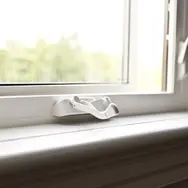 White coloured frame of a window with a latch
