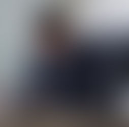 Male Lawyer working at table in office, focus on scales of justice.