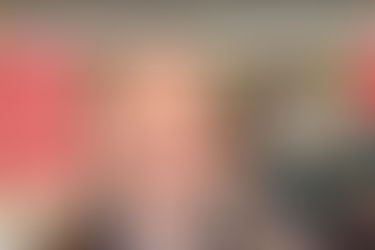 A person stands outside McCourt Law Offices, with a red exterior and snow on the ground. A black car is parked nearby.