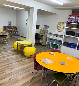 A vibrant playroom featuring colorful tables