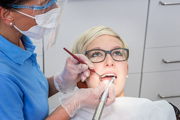 Woman with professional dental cleaning in dental practice