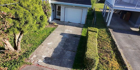 High-angle view of an old, worn concrete driveway