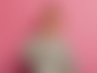 Joyful small red haired female kid points at tooth