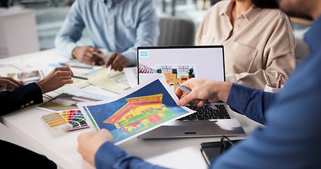 A group collaborates at a table with design materials