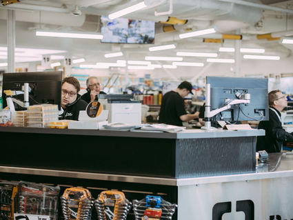 Friendly Veg Auto staff assisting customers at the front counter