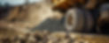 Powerful dump truck wheel in a dusty construction site environment