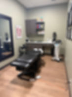Medical treatment room with adjustable exam table.