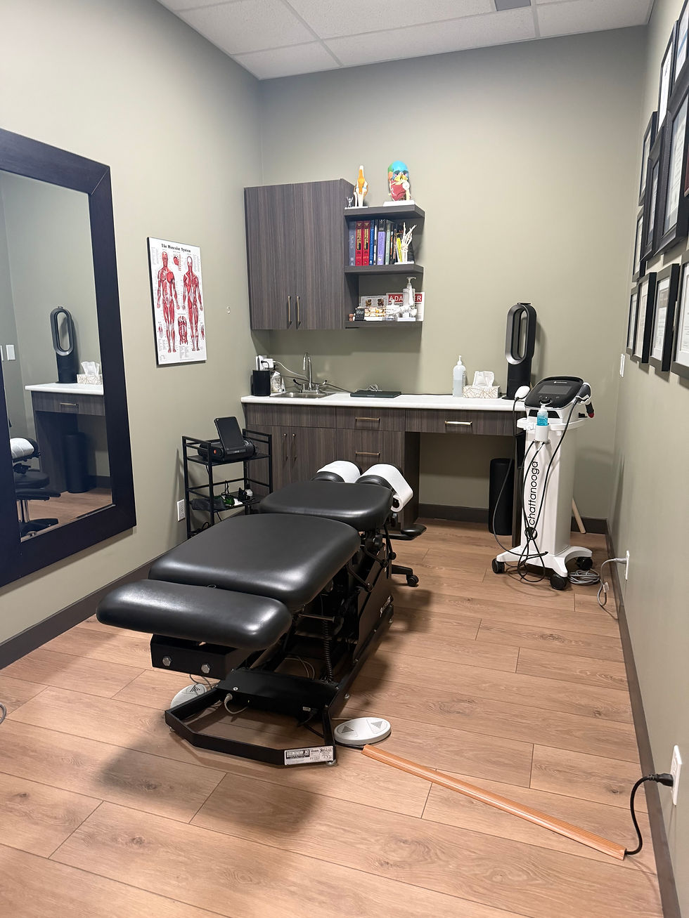Medical treatment room with adjustable exam table.