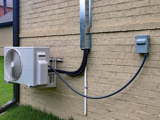 Air Conditioner mini split system next to home.