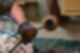 Hands of a plumber as he runs a camera scope and cleaning machine through the main pipe to unclog the drain to the Septic System