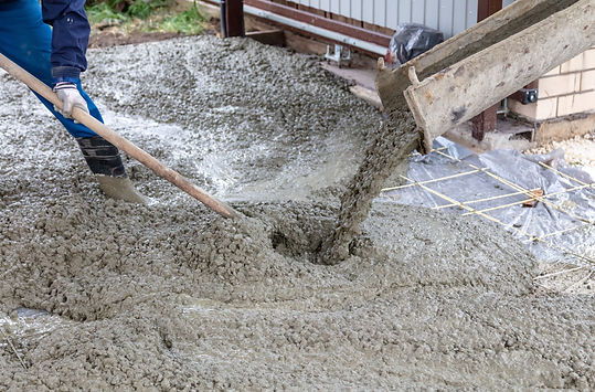 Workers level out the concrete mix at a construction site