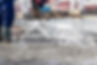 Builders workers pour concrete floor in industrial workshop