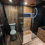 Commode and shower area positioned side by side