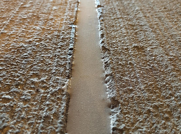 Close-up view of a wall featuring a prominent crack running vertically through the surface