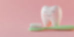 Happy tooth with toothbrush on pink background