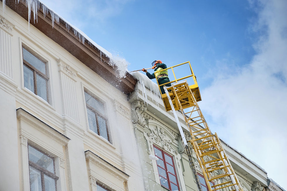 Ice dam removal from a commercial building roof using an elevated work platform
