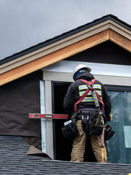 A person working on the roof of a house