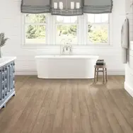 Beautiful flooring of a bathroom with a bathtub and cabinet on top