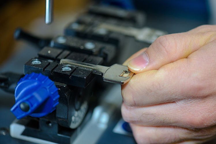 A man puts a key to craft out its duplicate.