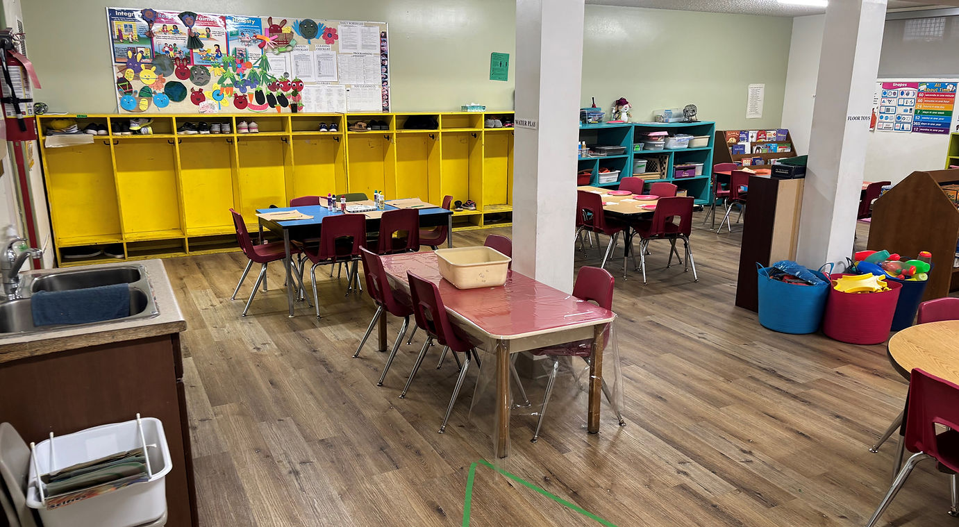 A classroom featuring several tables and chairs arranged for student seating and learning activities