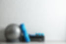 Set of fitness inventory on floor near brick wall