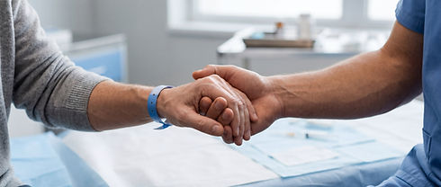 close-up of two people holding hands in gentle comfort