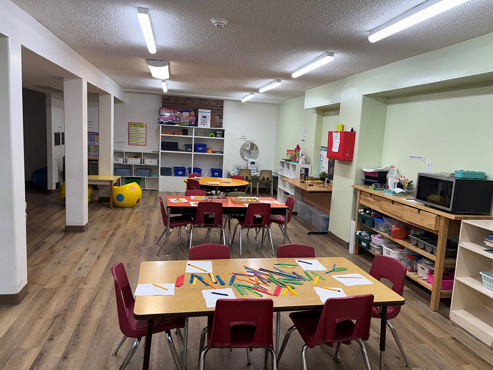 An interior view of a classroom with neatly arranged tables and chairs